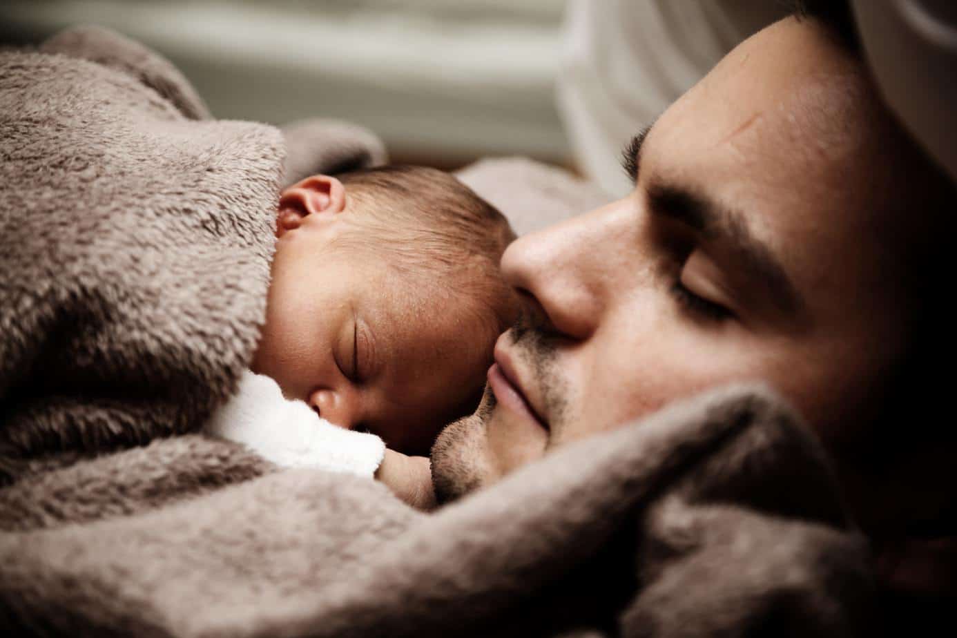 Father and sleeping baby